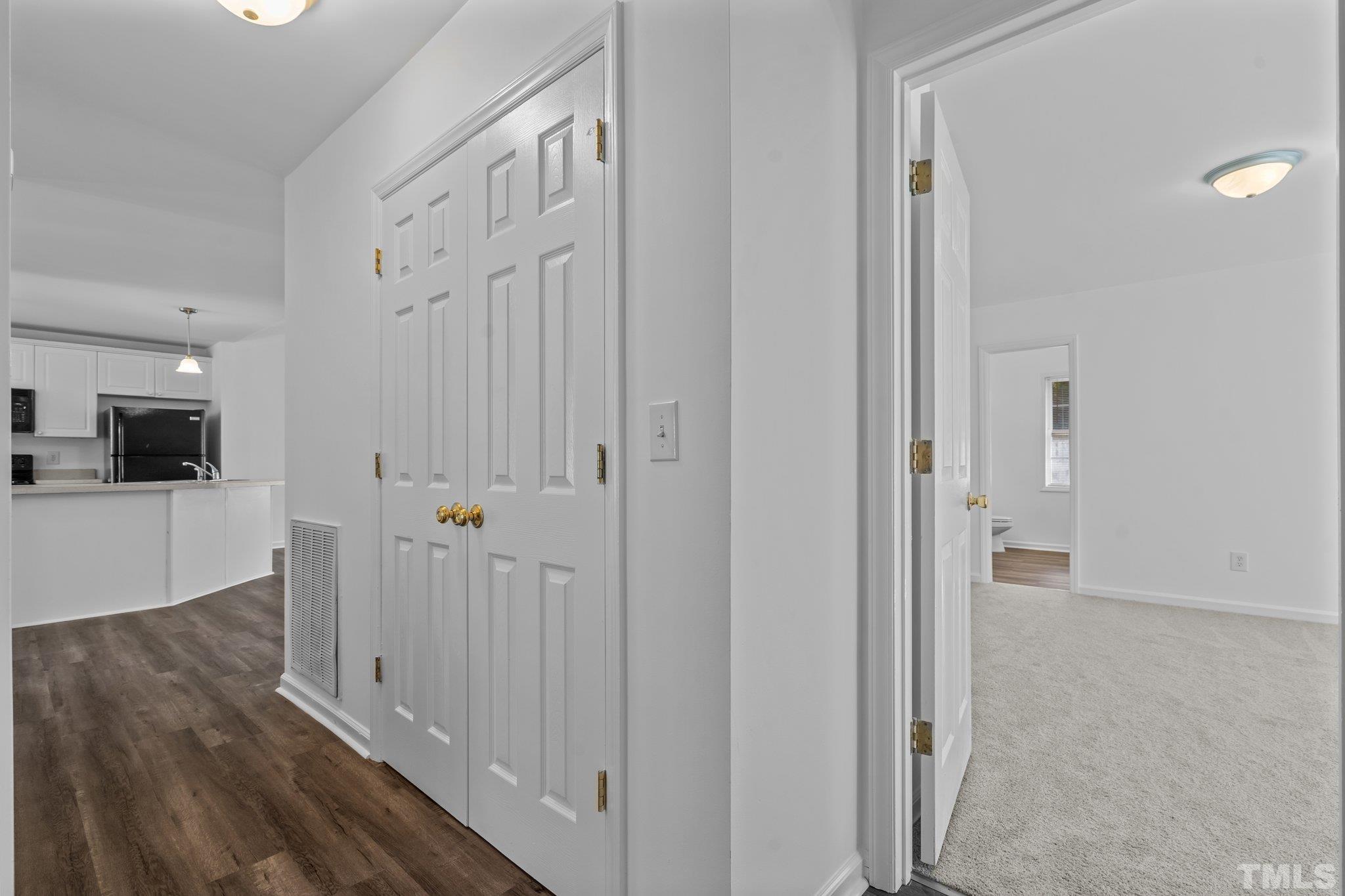 302 Laurel Drive Smithfield, NC 27577 - Photo 18 of 38 a view of a hallway with wooden floor and staircase