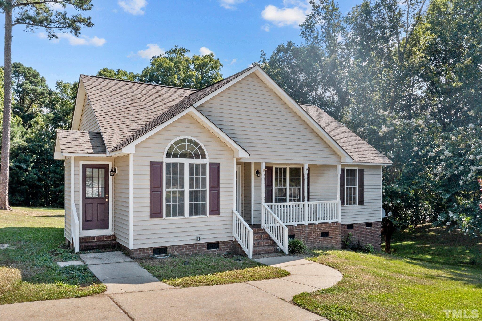 302 Laurel Drive Smithfield, NC 27577 - Photo 2 of 38 a view of a house with a yard and potted plants