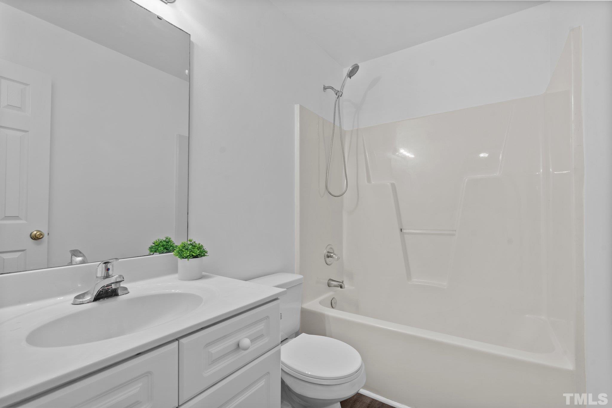 302 Laurel Drive Smithfield, NC 27577 - Photo 26 of 38 a bathroom with a sink a toilet and shower