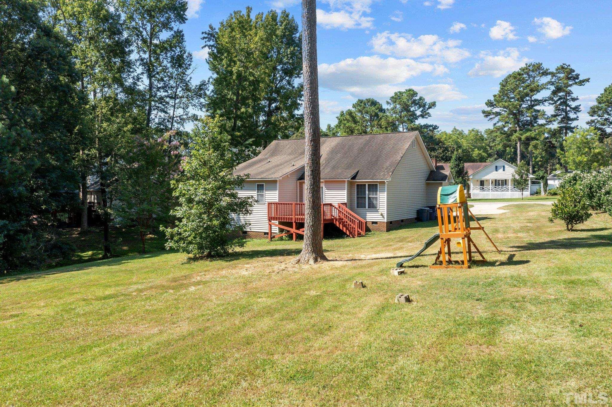 302 Laurel Drive Smithfield, NC 27577 - Photo 35 of 38 a view of swimming pool with seating area and small yard
