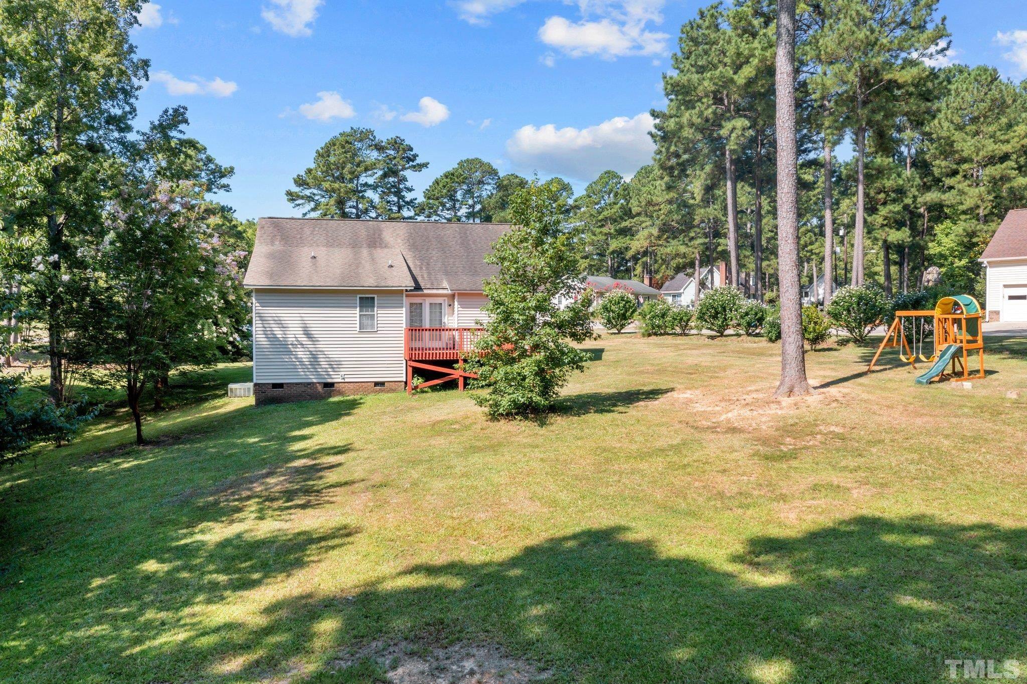 302 Laurel Drive Smithfield, NC 27577 - Photo 36 of 38 a view of a house with a backyard and a tree