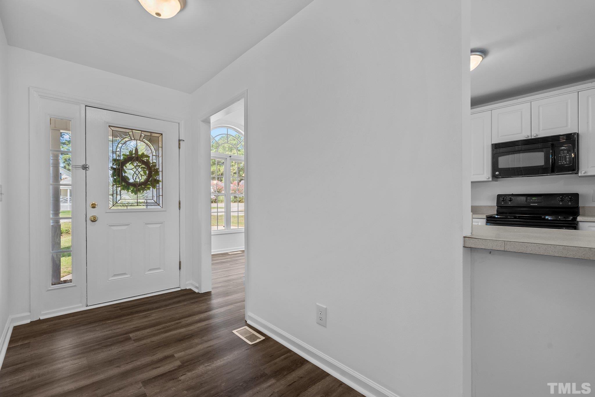 302 Laurel Drive Smithfield, NC 27577 - Photo 6 of 38 a view of kitchen with wooden floor electronic appliances and window