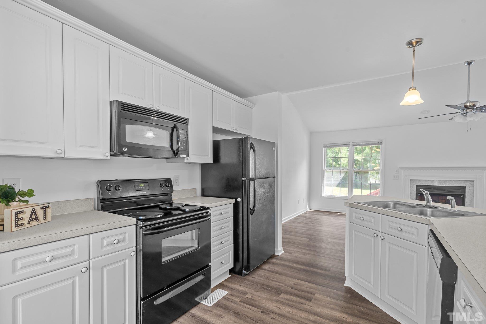 302 Laurel Drive Smithfield, NC 27577 - Photo 10 of 38 a kitchen with sink a microwave and cabinets