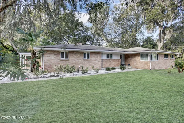 a front view of house with yard and green space