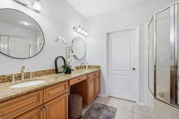 a bathroom with a granite countertop sink mirror and vanity