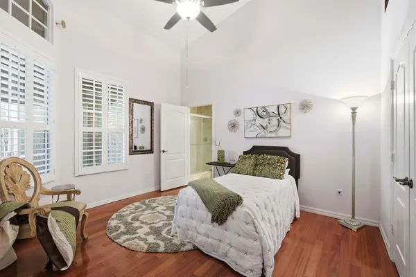 a bedroom with a bed and wooden floor