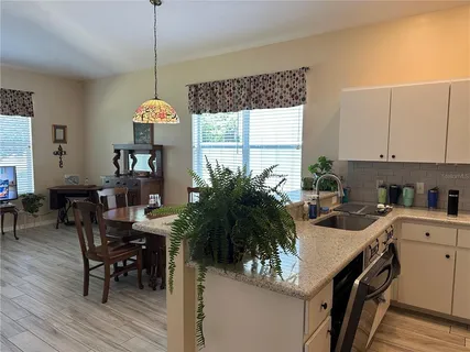a kitchen with a table and chairs in it