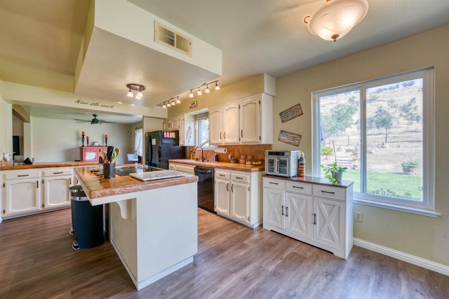 15656 Millerton Road Prather, CA 93651 - Photo 18 of 56 a kitchen with stainless steel appliances granite countertop wooden floors and white cabinets
