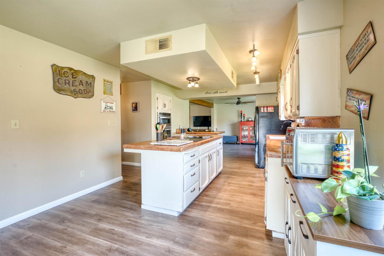 15656 Millerton Road Prather, CA 93651 - Photo 20 of 56 a large kitchen with a lot of counter space and wooden floor
