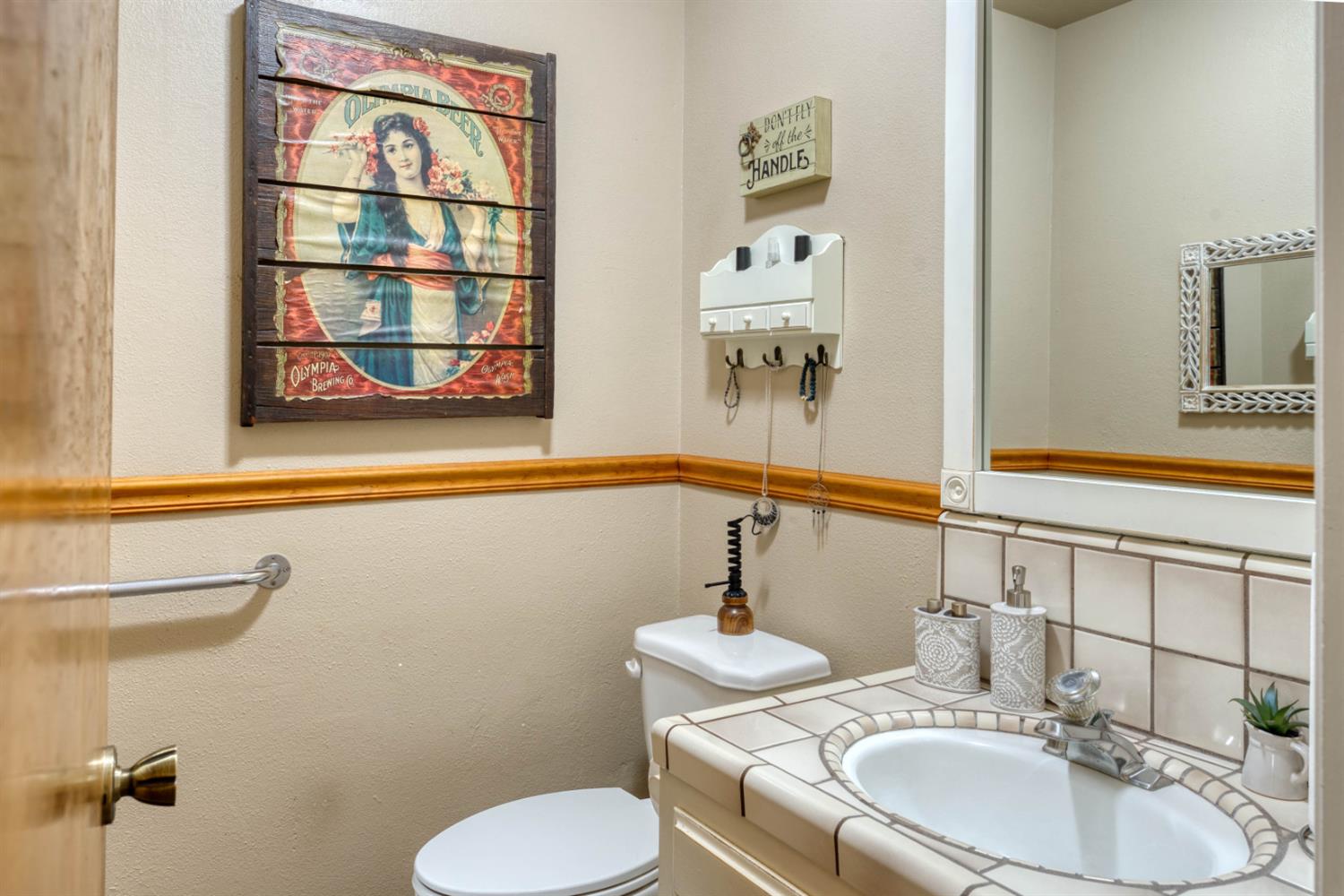 15656 Millerton Road Prather, CA 93651 - Photo 27 of 56 a bathroom with a toilet sink and mirror