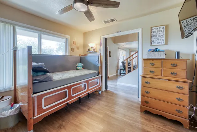 a bedroom with furniture and a chandelier