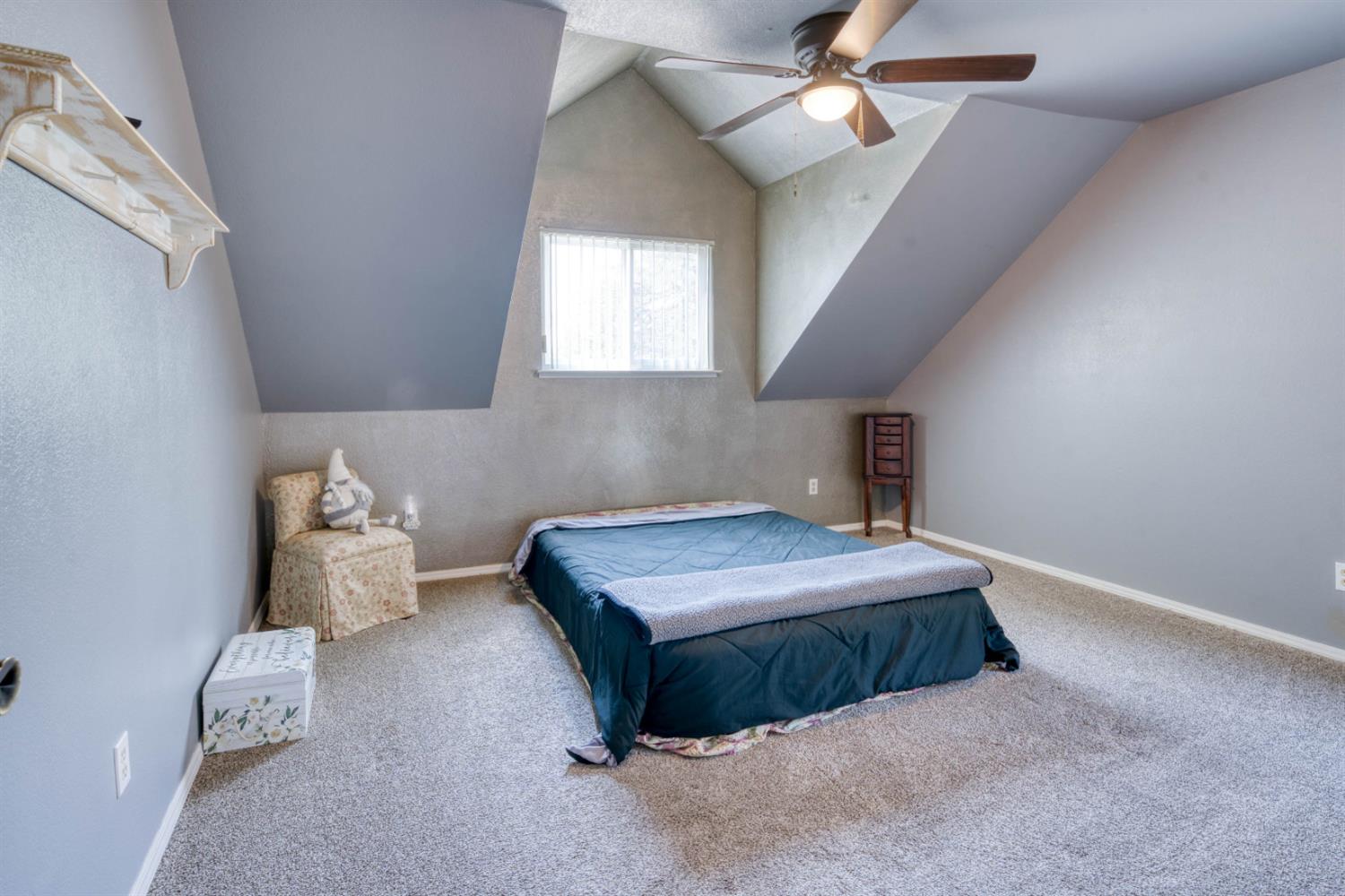 15656 Millerton Road Prather, CA 93651 - Photo 37 of 56 a bedroom with a bed and a chandelier fan