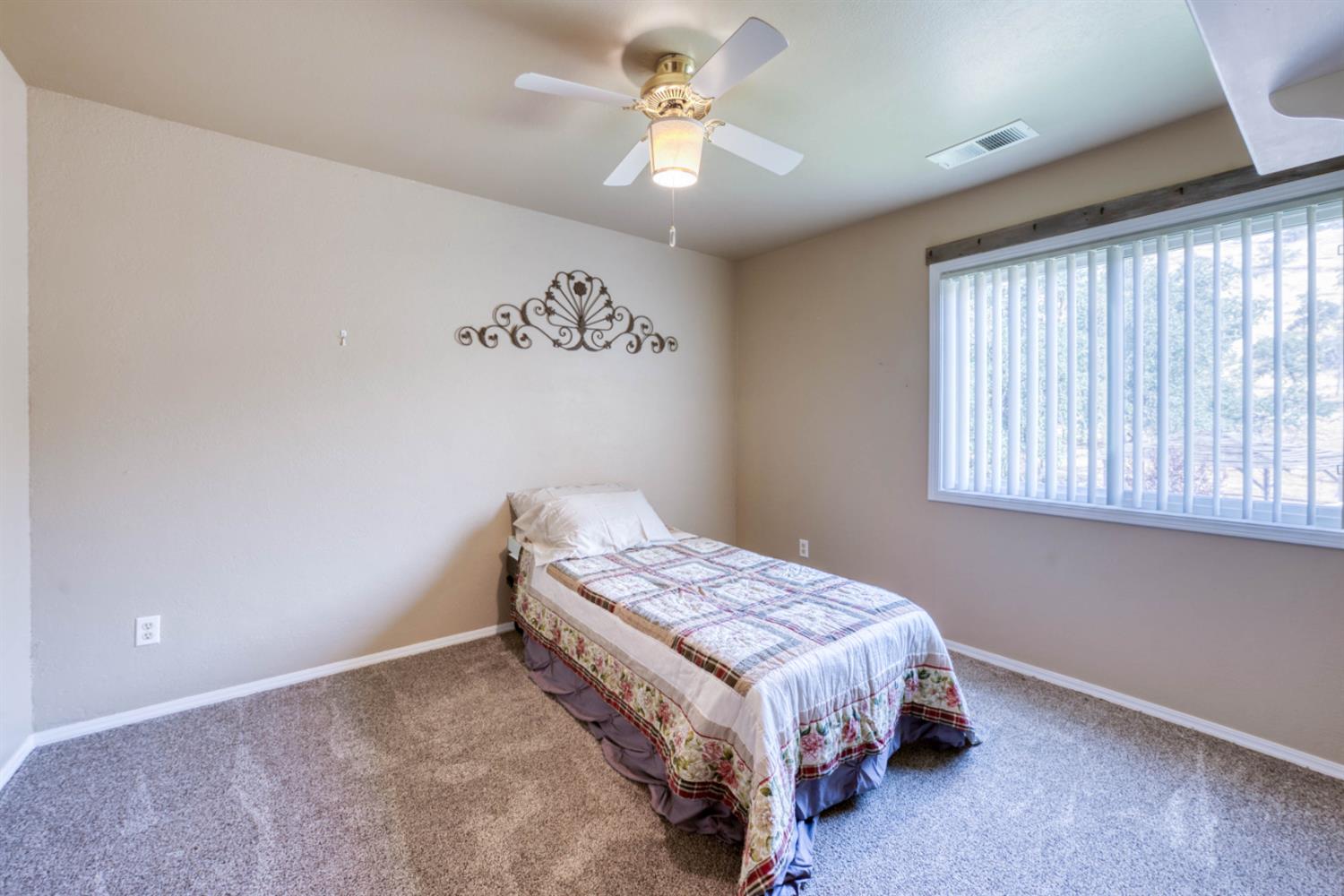 15656 Millerton Road Prather, CA 93651 - Photo 40 of 56 a bedroom with a bed and a chandelier