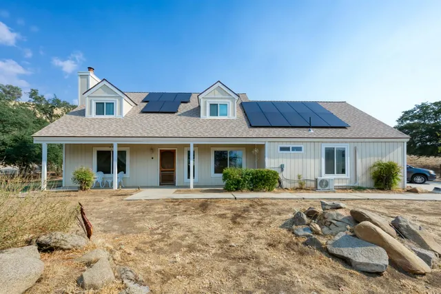 a large kitchen with kitchen island a stove a sink dishwasher and wooden cabinets with wooden floor