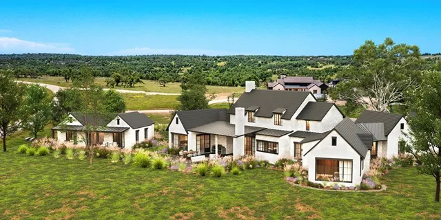 a view of a house with a big yard and potted plants