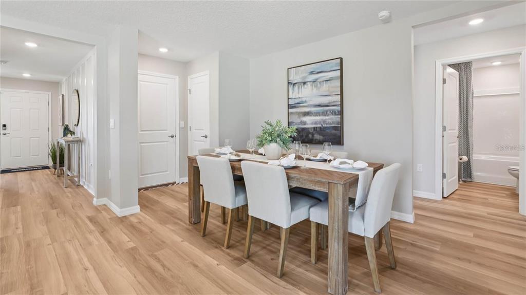 5772 Southwest 132nd Place Ocala, FL 34473 - Photo 4 of 11 a view of a dining room with furniture and wooden floor