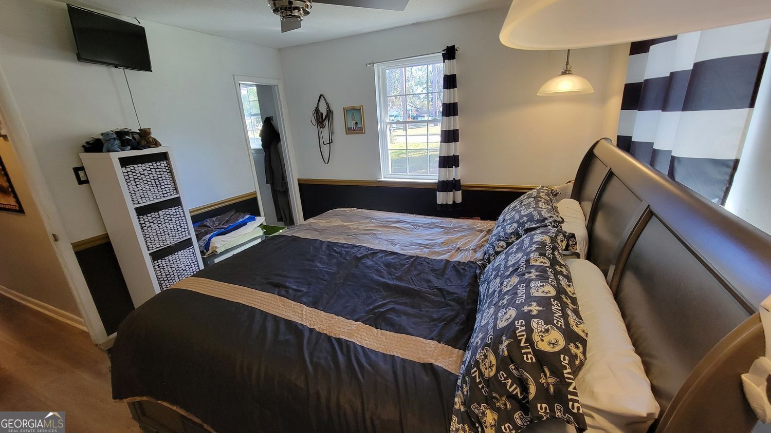 128 Wassaw Road Savannah, GA 31410 - Photo 11 of 22 a bedroom with a bed and a flat tv screen on the dresser