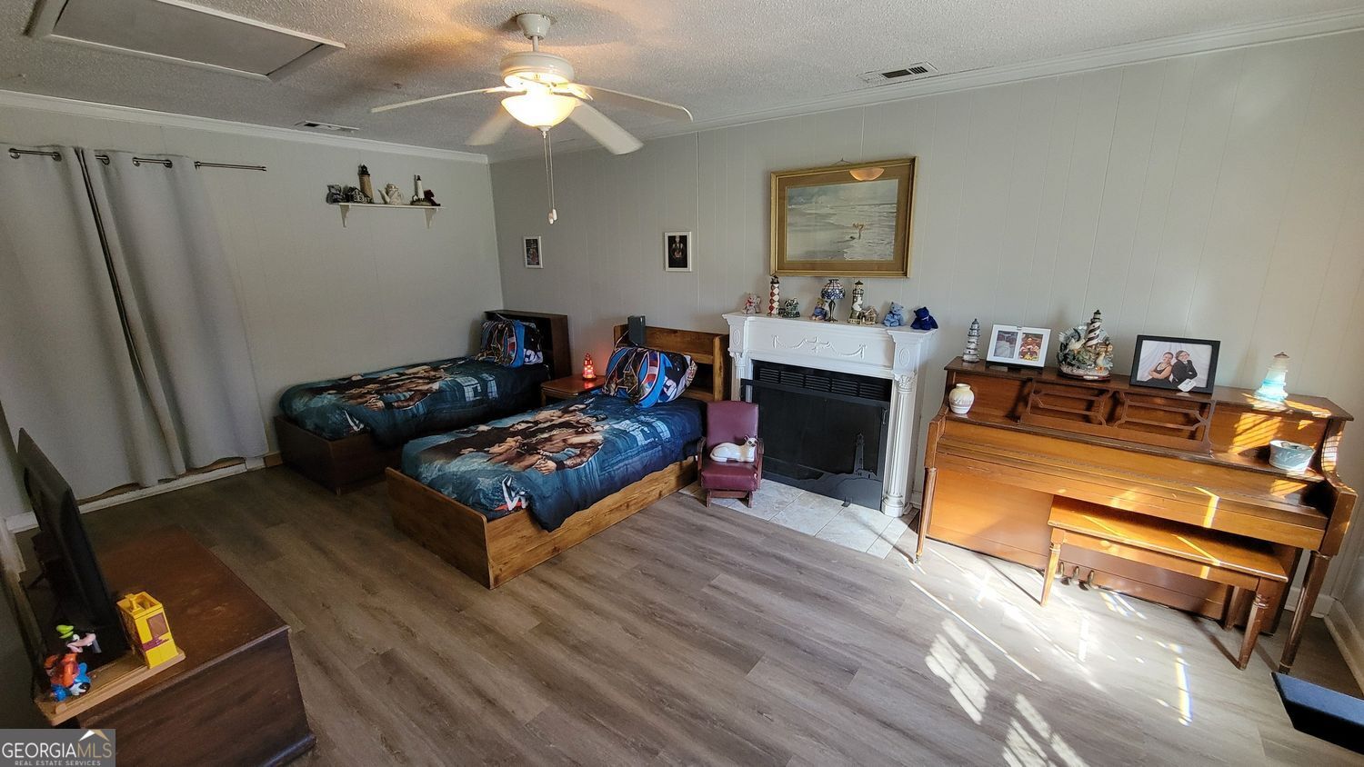 128 Wassaw Road Savannah, GA 31410 - Photo 7 of 22 a living room with furniture a flat screen tv and a fireplace