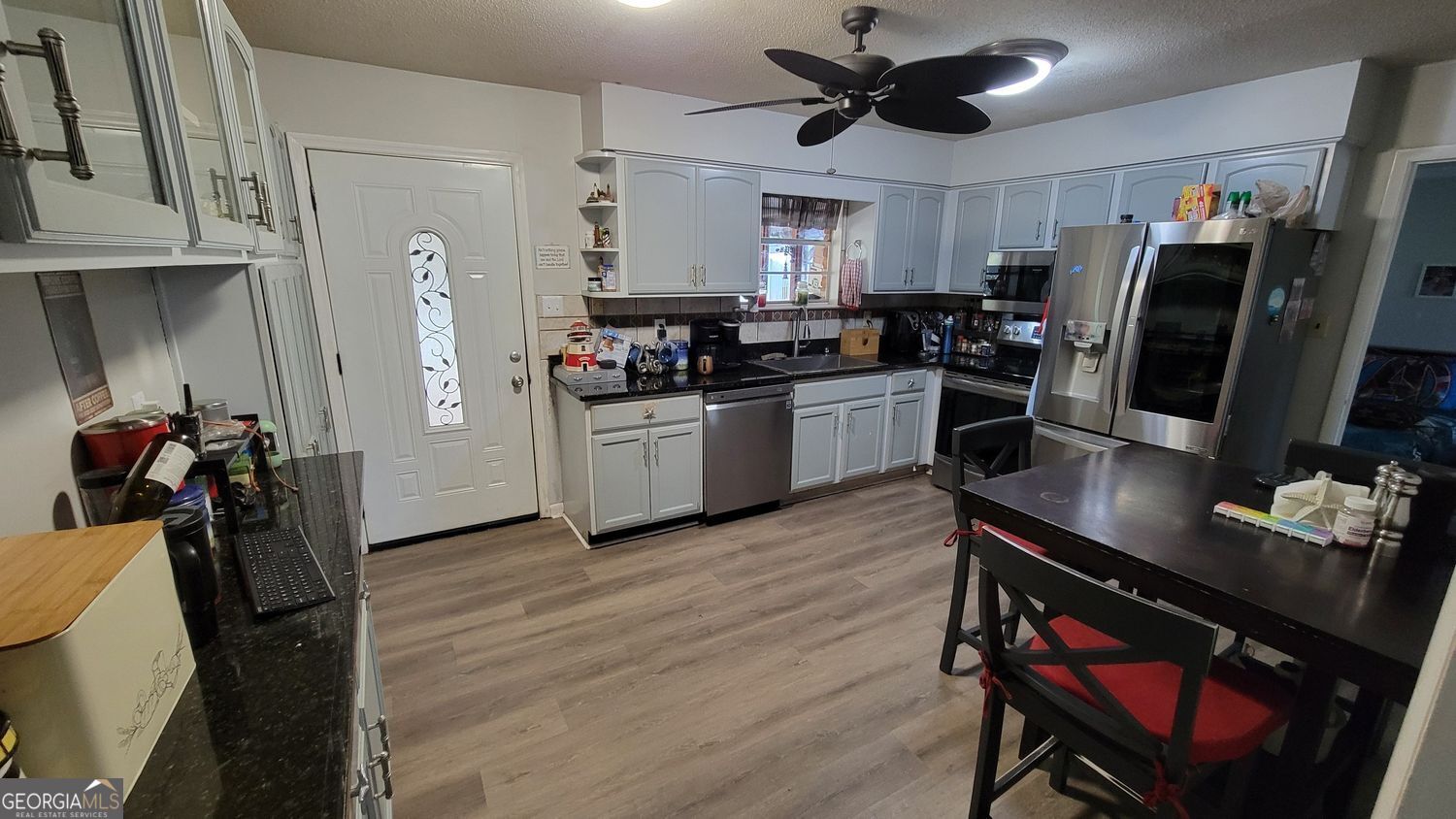 128 Wassaw Road Savannah, GA 31410 - Photo 10 of 22 a kitchen with stainless steel appliances a sink stove refrigerator and cabinets