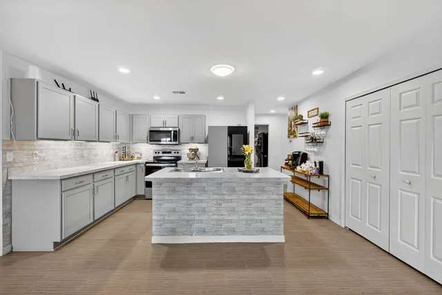 a kitchen with a sink stainless steel appliances and cabinets