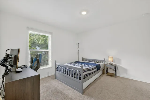 a bedroom with a bed and a window