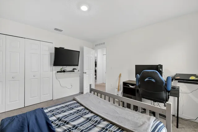 a living room with furniture and a piano