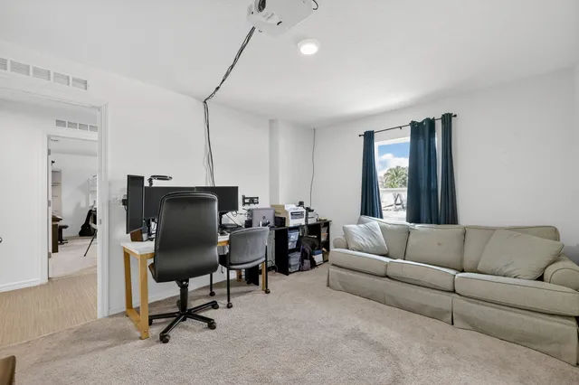 a livingroom with a workspace