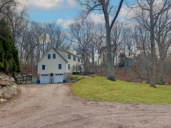 a view of a house with a yard covered in snow