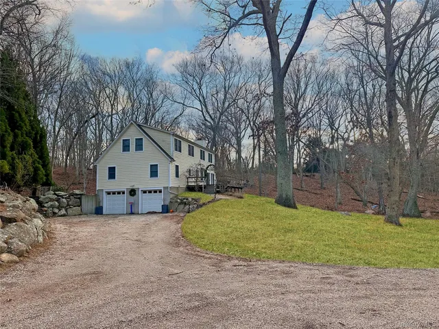 a view of a house with a yard covered in snow