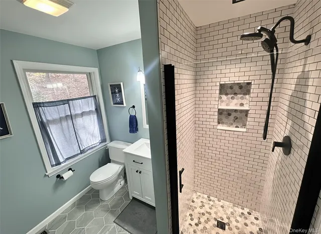 a bathroom with a toilet and a shower