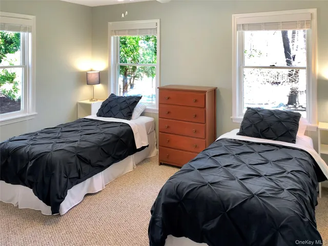 a bedroom with a bed window and a lamp