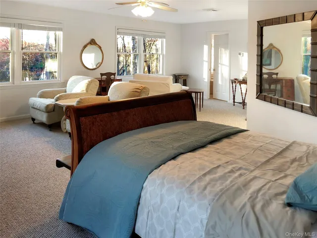 a bedroom with double bed and a large window