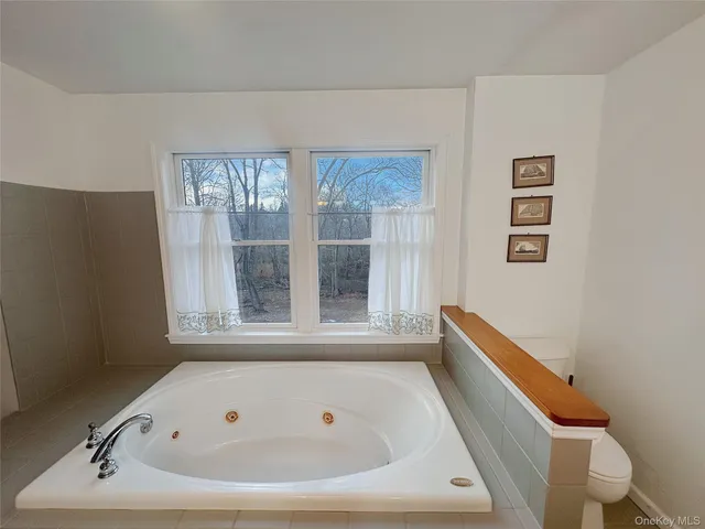 a bathroom with a bathtub and window