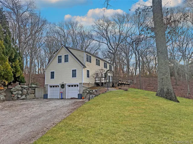 a view of a house with a yard and sitting area