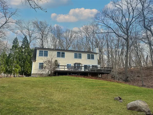 a view of a house with a back yard and sitting area