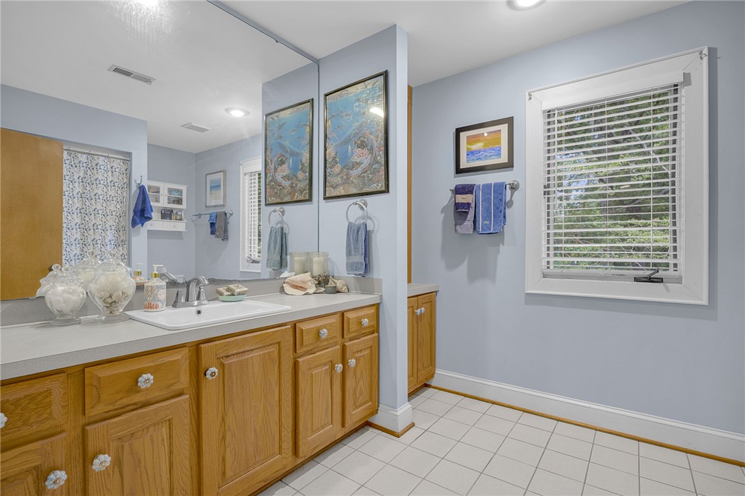 218 Northridge Drive Anderson, SC 29621 - Photo 33 of 50 A well-appointed bathroom offers a practical vanity with ample storage, complemented by crisp white tile flooring.