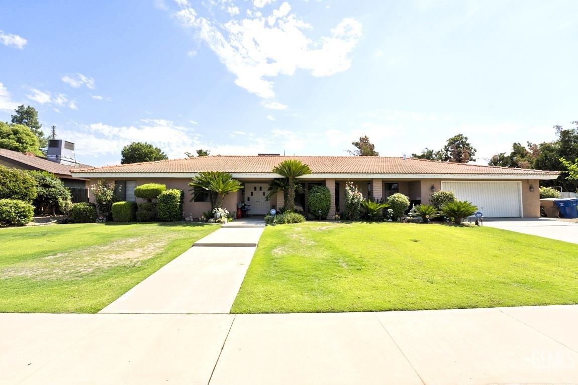 a view of swimming pool with outdoor seating and a garden