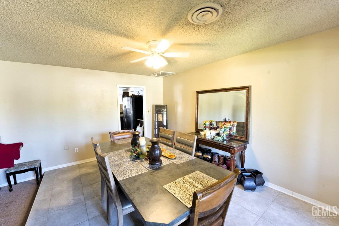 Undisclosed Address Bakersfield, CA 93309 - Photo 12 of 37 a view of a dining room with furniture and wooden floor