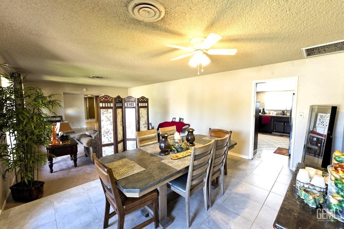 Undisclosed Address Bakersfield, CA 93309 - Photo 13 of 37 a view of a dining room with furniture and wooden floor