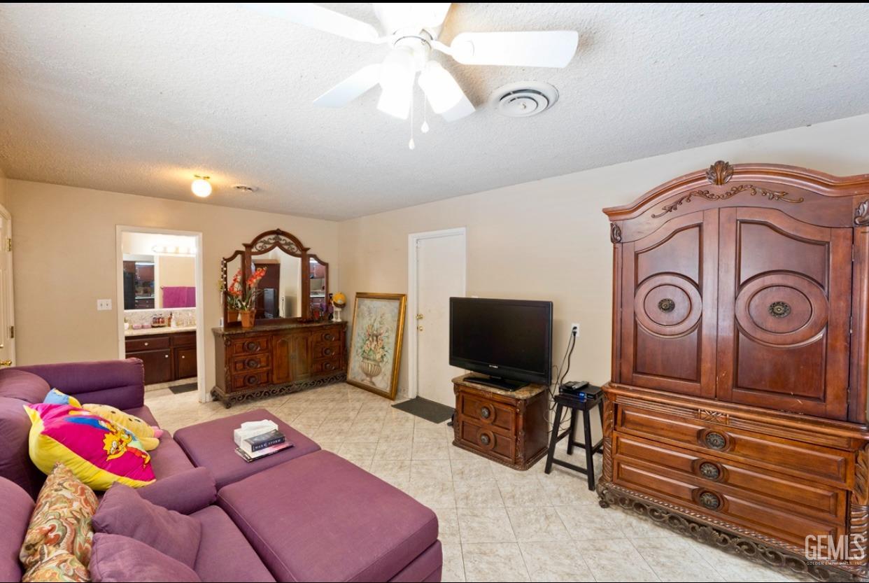 Undisclosed Address Bakersfield, CA 93309 - Photo 14 of 37 a living room with furniture and a flat screen tv