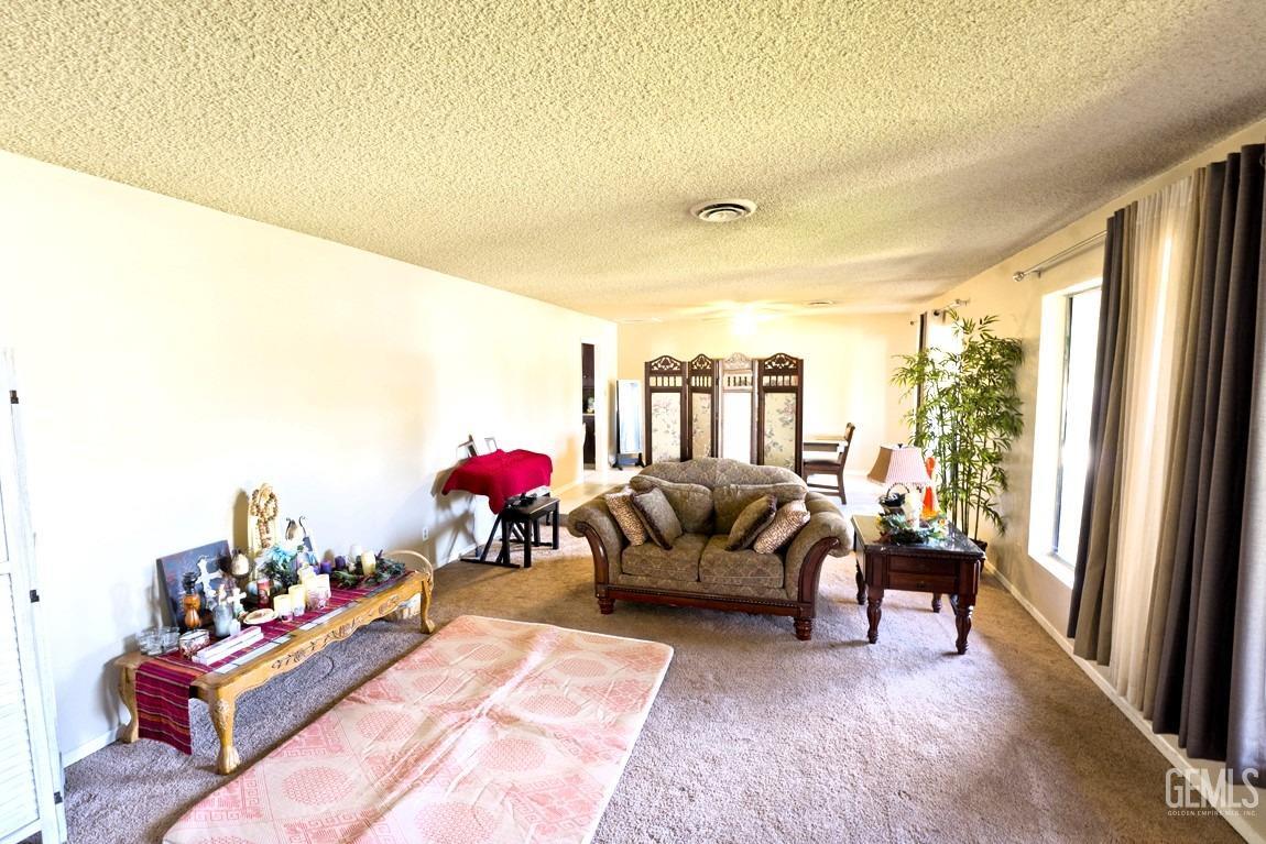 Undisclosed Address Bakersfield, CA 93309 - Photo 15 of 37 a living room with furniture and a large window
