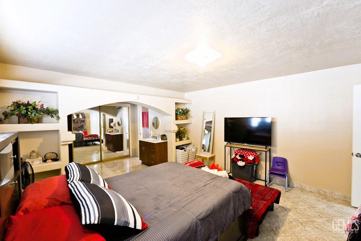 Undisclosed Address Bakersfield, CA 93309 - Photo 23 of 37 a bedroom with furniture and a flat screen tv