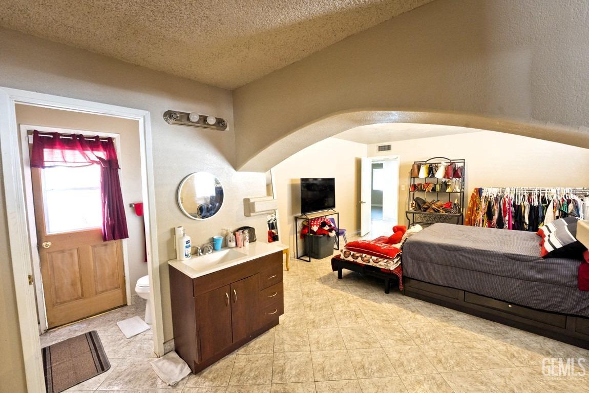 Undisclosed Address Bakersfield, CA 93309 - Photo 24 of 37 a living room with furniture and a mirror