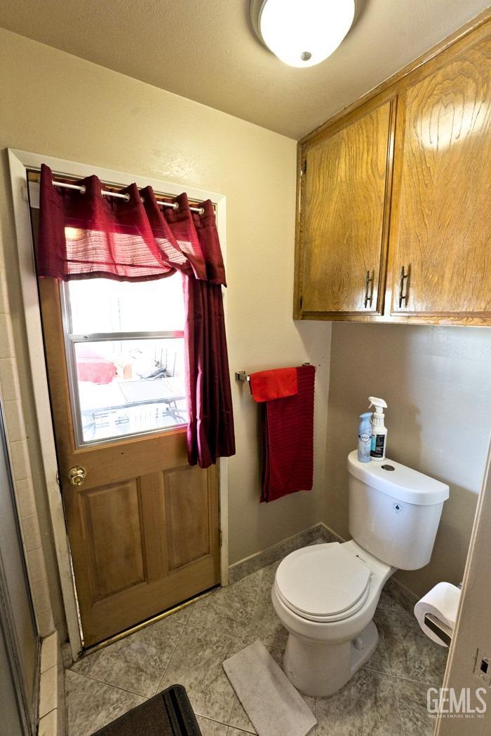 Undisclosed Address Bakersfield, CA 93309 - Photo 28 of 37 a bathroom with a toilet sink and mirror