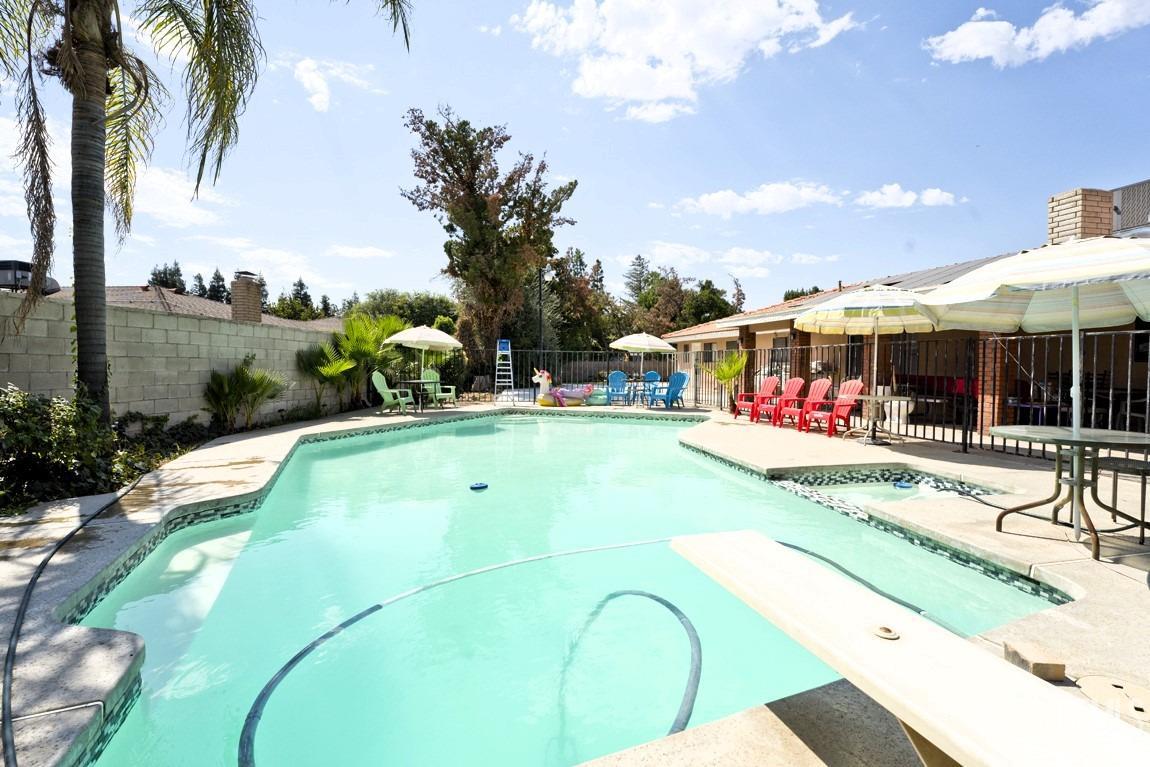 Undisclosed Address Bakersfield, CA 93309 - Photo 31 of 37 a view of a swimming pool with a garden and plants