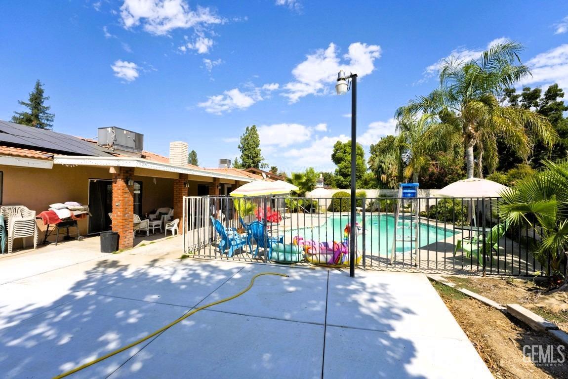 Undisclosed Address Bakersfield, CA 93309 - Photo 34 of 37 a view of a patio with a table and chairs under an umbrella
