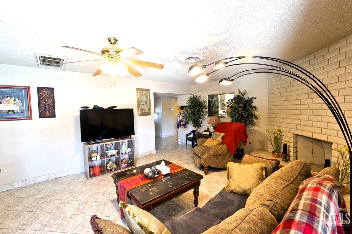 Undisclosed Address Bakersfield, CA 93309 - Photo 4 of 37 a living room with furniture and a flat screen tv