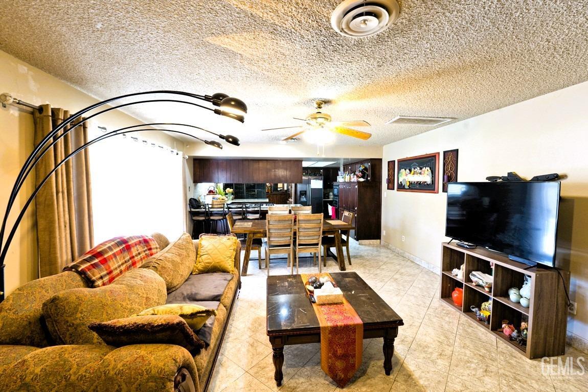 Undisclosed Address Bakersfield, CA 93309 - Photo 5 of 37 a living room with furniture and a flat screen tv