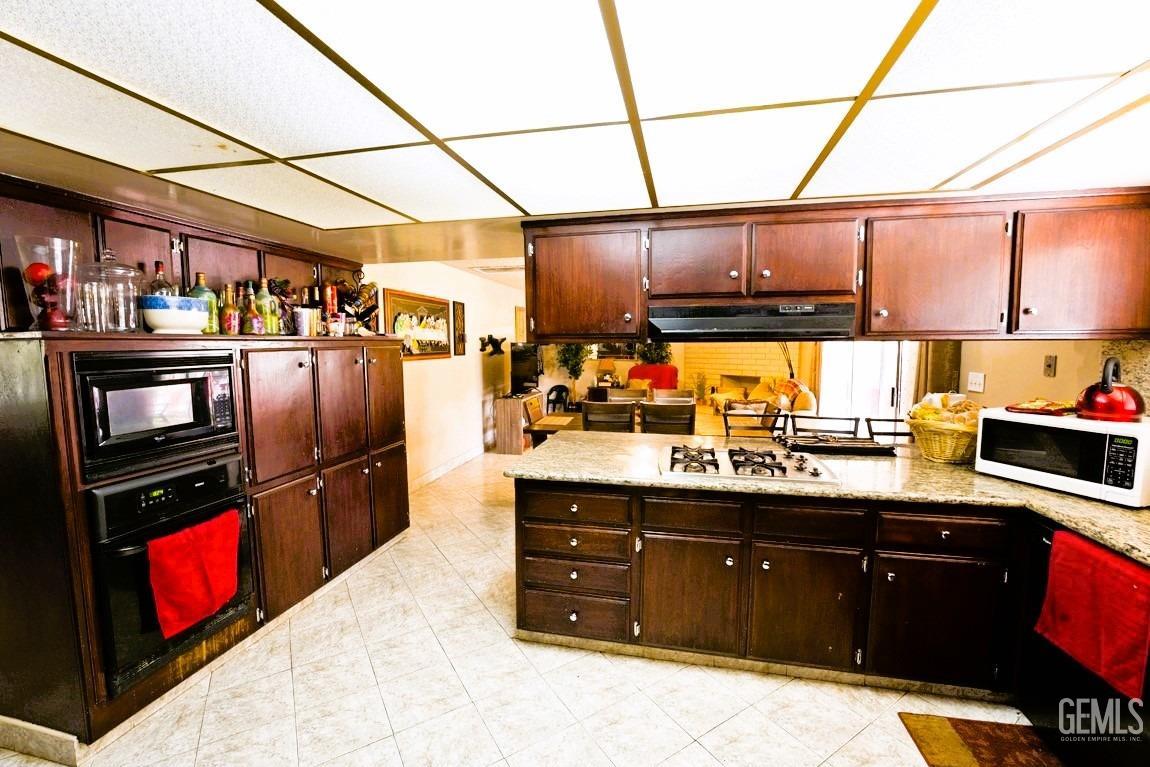 Undisclosed Address Bakersfield, CA 93309 - Photo 8 of 37 a kitchen with stainless steel appliances granite countertop a sink and a refrigerator