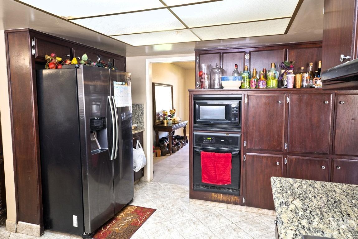 Undisclosed Address Bakersfield, CA 93309 - Photo 10 of 37 a kitchen with stainless steel appliances granite countertop a refrigerator and a stove